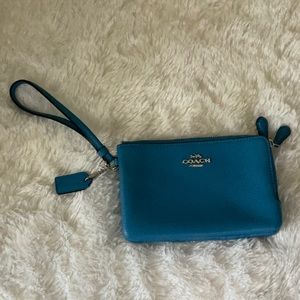 Coach wristlet with two zippered compartments.
